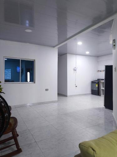 a living room with white walls and a couch at Casa Isabel in Santa Cruz de Mompox