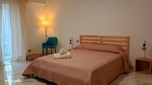 a bedroom with a bed and a blue chair at La piazza in San Giorgio la Molara