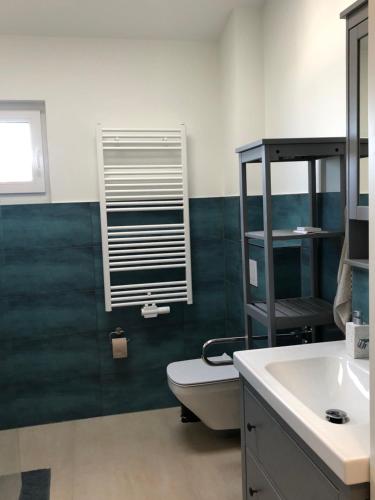 a bathroom with a toilet and a sink at Fewo Lia in Niederdorla