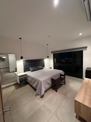 ein Schlafzimmer mit einem großen Bett und einem Fernseher in der Unterkunft Charming apartment with a nice view in San Salvador