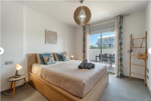 a bedroom with a bed with a table and a balcony at Tejita Beach in La Tejita