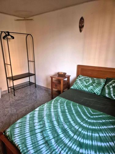 a bedroom with a bed and a mirror and a ladder at Palm and Pillow in Freetown