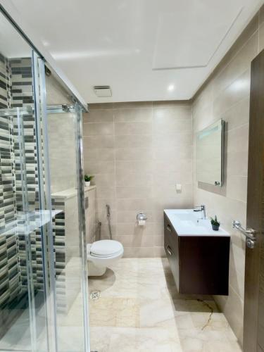 a bathroom with a toilet and a sink and a shower at Agadir bay luxury in Agadir