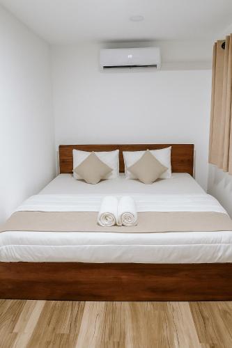 a bedroom with a bed with two towels on it at Noa Sands By Ceylon Vistas in Talpe
