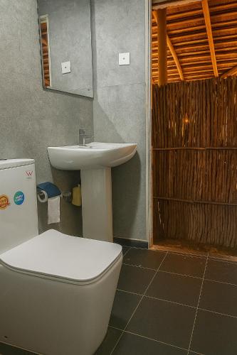 a bathroom with a toilet and a sink at Noa Sands By Ceylon Vistas in Talpe