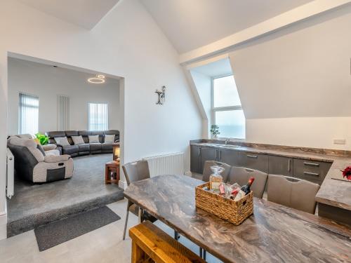 a living room with a table and a couch at Sea View Penthouse - Regency Mansion in Redcar