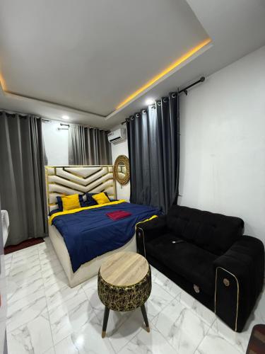 a bedroom with a bed and a couch at Beautiful single room studio apartment in Ilasan lekki magnanimous in Lekki