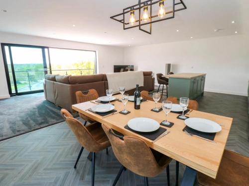 a dining room with a wooden table and chairs at Silverbirch Cottage - 3 Bedrooms - Sleeps 6 in Frizington