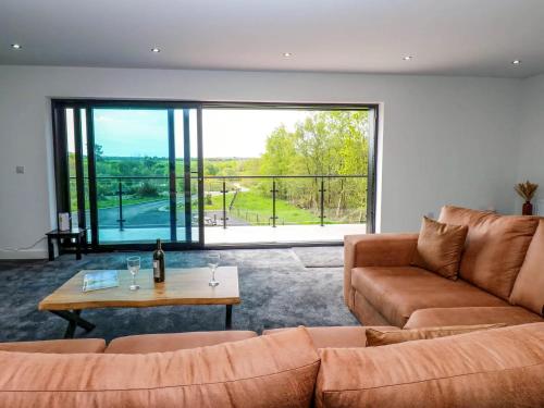 a living room with a couch and a table at Silverbirch Cottage - 3 Bedrooms - Sleeps 6 in Frizington