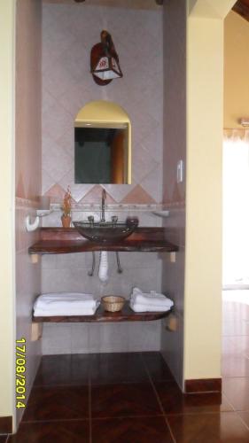 a bathroom with a sink and a mirror at Cabañas Alünmew in Juana Koslay 