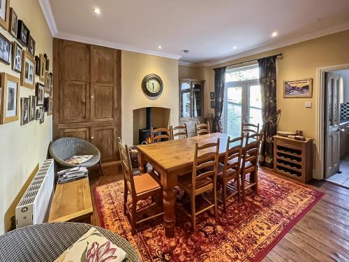 a dining room with a table and chairs at Lancashire And Yorkshire Cottage in Hellifield