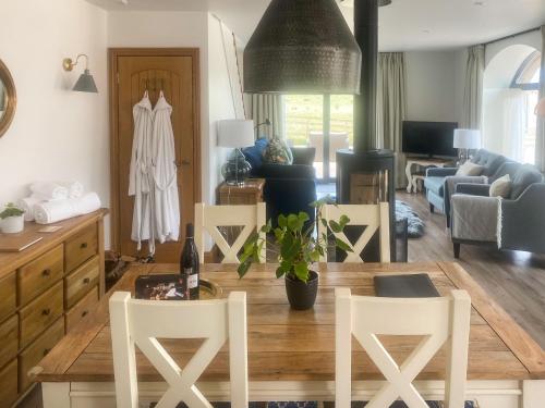 a living room with a table and white chairs at The Cart House in Duns