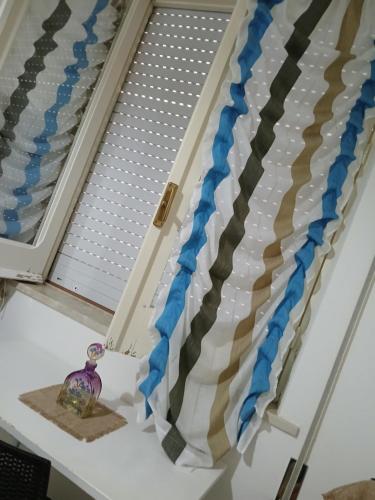 a window sill with a curtain in a bedroom at La casa di Dea in Marsala