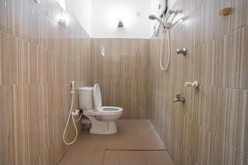 a bathroom with a toilet and a shower at Medawatta Villa in Mirissa
