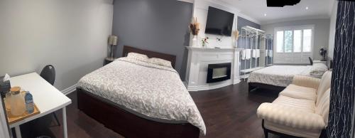 a bedroom with a bed and a fireplace at F3 Spacious room with 2 queen beds and TV in Mississauga