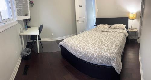 a bedroom with a bed and a desk and a window at Private Single Bedroom in City Centre Q66 in Mississauga