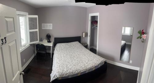 a bedroom with a bed and a desk in it at Bright Private Single Bedroom Q33 in Mississauga