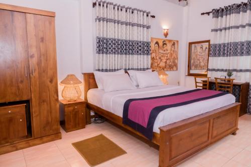 Ένα ή περισσότερα κρεβάτια σε δωμάτιο στο Daions Villa Mirissa