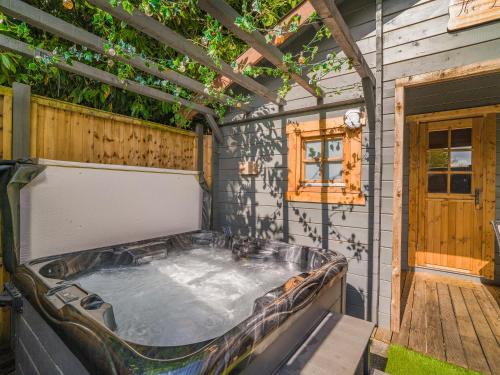 a hot tub in the back of a house at The Lodge - Uk50409 in Bisterne