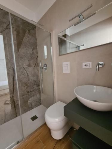 a bathroom with a sink and a toilet and a shower at La Casa di Nonna in Conversano