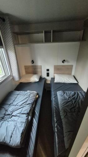 Ένα ή περισσότερα κρεβάτια σε δωμάτιο στο Mobil-Home, camping LES DUNES 5 étoiles, 6 personnes