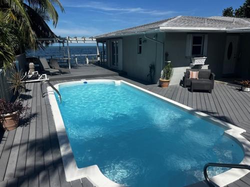a swimming pool on a deck next to a house at Caribbean Sunsets in Marathon