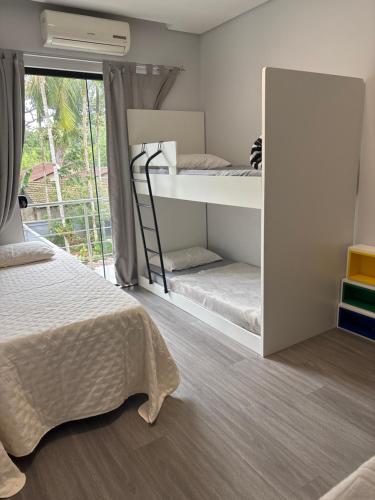 a bedroom with two bunk beds and a window at Casa Privativa Prox Expoville e Centro Com 2 Suítes in Joinville
