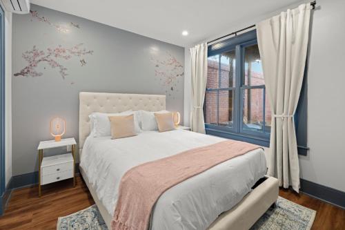 a bedroom with a large bed and a window at 2BR Capitol hill delight, with private parking in Washington, D.C.