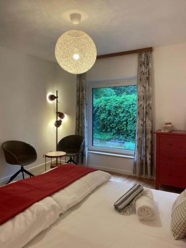 a bedroom with a bed with a large window at Springhouse in Bad Gastein