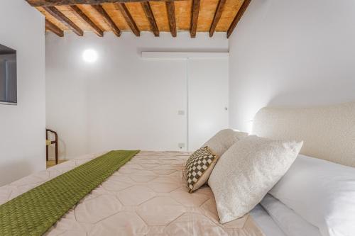 a bedroom with a bed with two pillows on it at Fumo di Lambrusco - Rua Frati 34 - Boutique Apartment in Modena