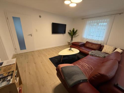 a living room with a couch and a table at Ferienwohnungen Bella in Reutte