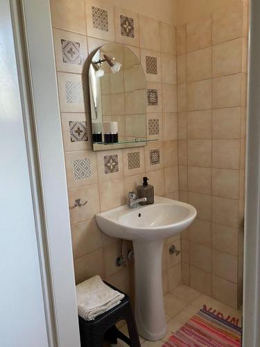 a bathroom with a sink and a mirror at Feels like home in Maniákoi