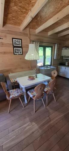 a dining room with a table and two chairs at Mała Bośnia in Bystrzyca Kłodzka