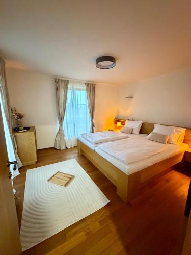 a bedroom with a large bed and a window at Chalet close to the Clouds in Špindlerův Mlýn