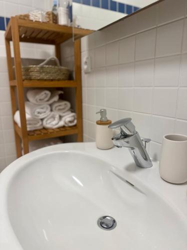 a white bathroom sink with a cup and a toothbrush at Chalet close to the Clouds in Špindlerův Mlýn