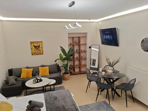 a living room with a couch and a table at Kerkétio guesthouse in Tríkala