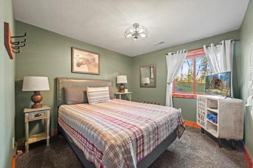 a bedroom with a bed and a window at 4 bedroom Cabin In Black Hills with Hot tub and Heated Pool in Lead
