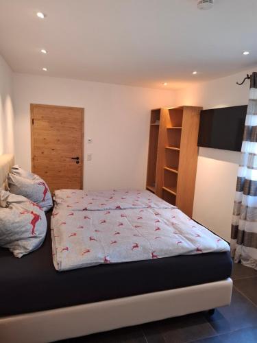 a bedroom with a bed and a book shelf at Chalet Ausweger - Strobl am Wolfgangsee in Strobl