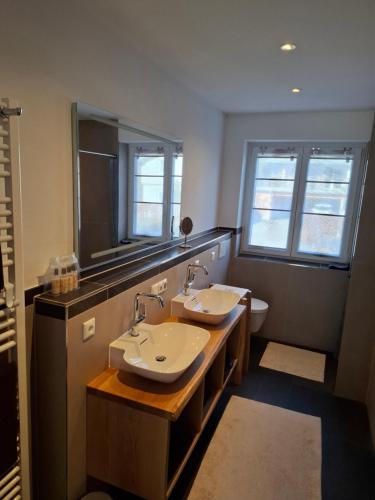 a bathroom with two sinks and a toilet at Chalet Ausweger - Strobl am Wolfgangsee in Strobl