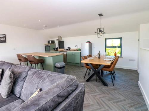 a living room and kitchen with a couch and a table at Sycamore Cottage - 2 Bedrooms - Sleeps 4 in Frizington