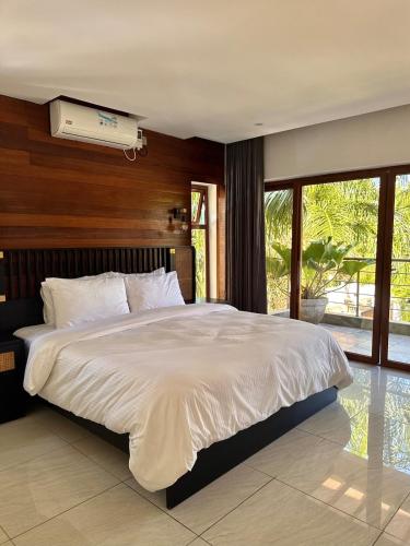 a bedroom with a large bed and a air conditioner at 5-Bedroom Luxury Villa with Pool, Near Diani Beach in Diani Beach