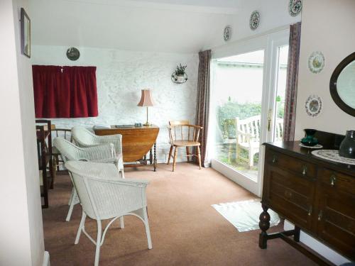 a living room with a table and chairs and a desk at Cropple Howe in Threlkeld