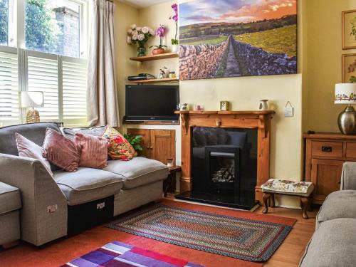 a living room with a couch and a fireplace at Church View in Skipton
