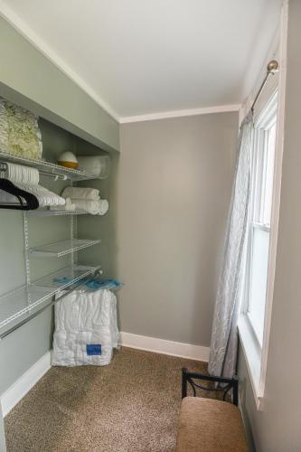 a room with a window and shelves with towels at Fully Remodeled, Charming Victorian Home in Rochester