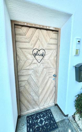 a wooden garage door with a heart painted on it at Auszeit im Chiemgau in Rottau
