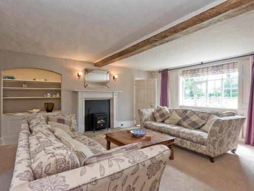 a living room with two couches and a fireplace at Cravens Manor in Sotherton