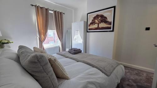 a bedroom with a bed with a tree on the wall at O & A Retreat in York