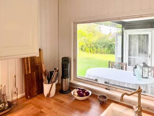 a kitchen counter with a window with a view of a garden at Get Close To Nature And The Starry Sky in Stege