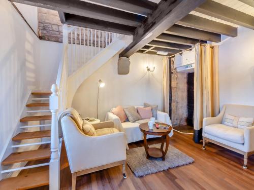 a living room with stairs and a couch and a table at Irishman's Tower in Riley Green