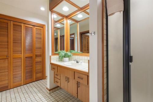 a bathroom with a sink and a mirror at 412 Ridge in Kahana